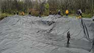 Photo of volunteers placing liner
