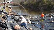 Photo of truck shooting stones on top of liner